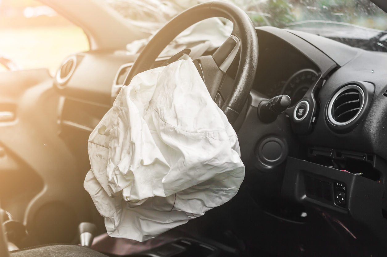 An airbag inflated from the steering wheel of a car which has been in an accident