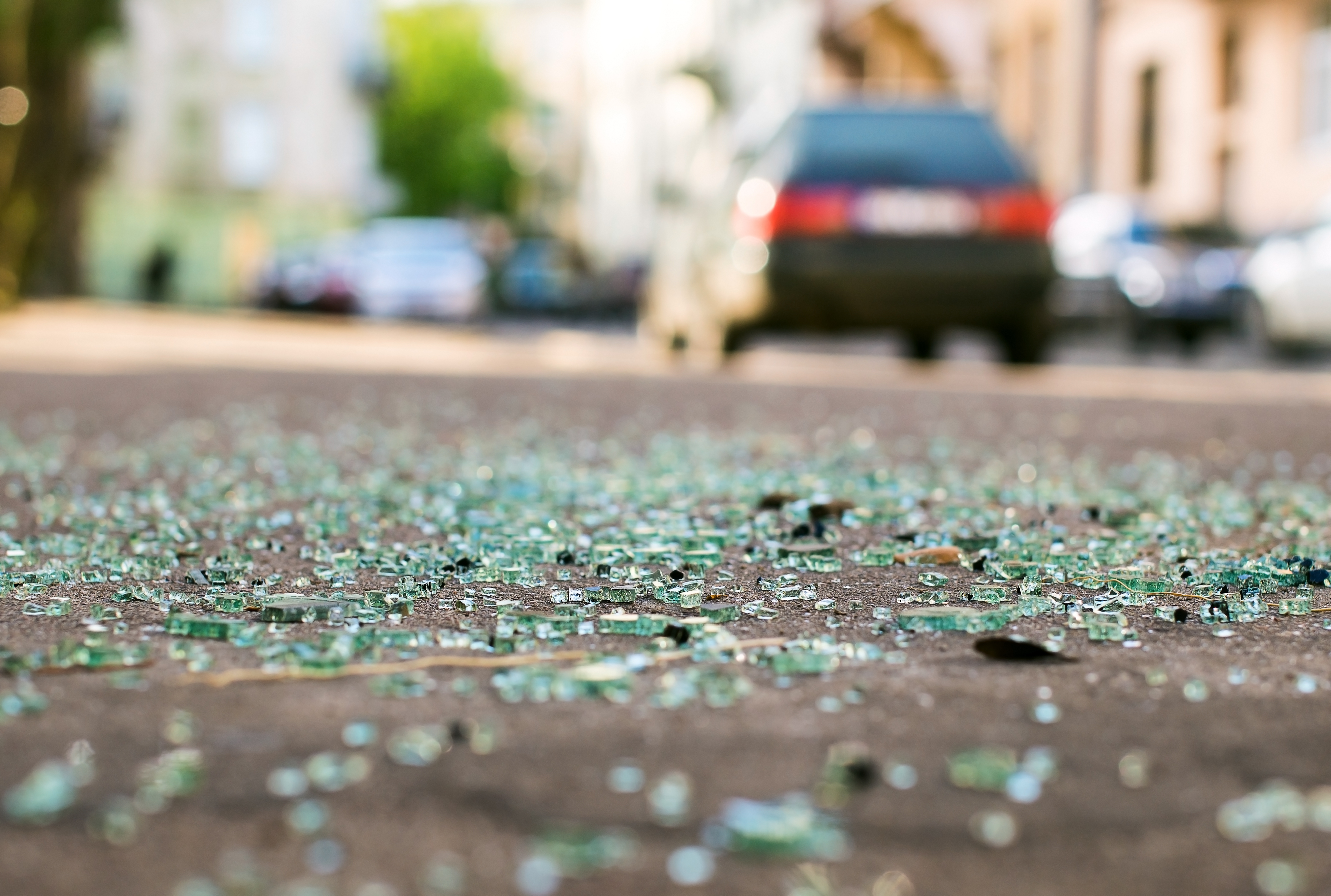Smashed glass lies on the road after a car accident