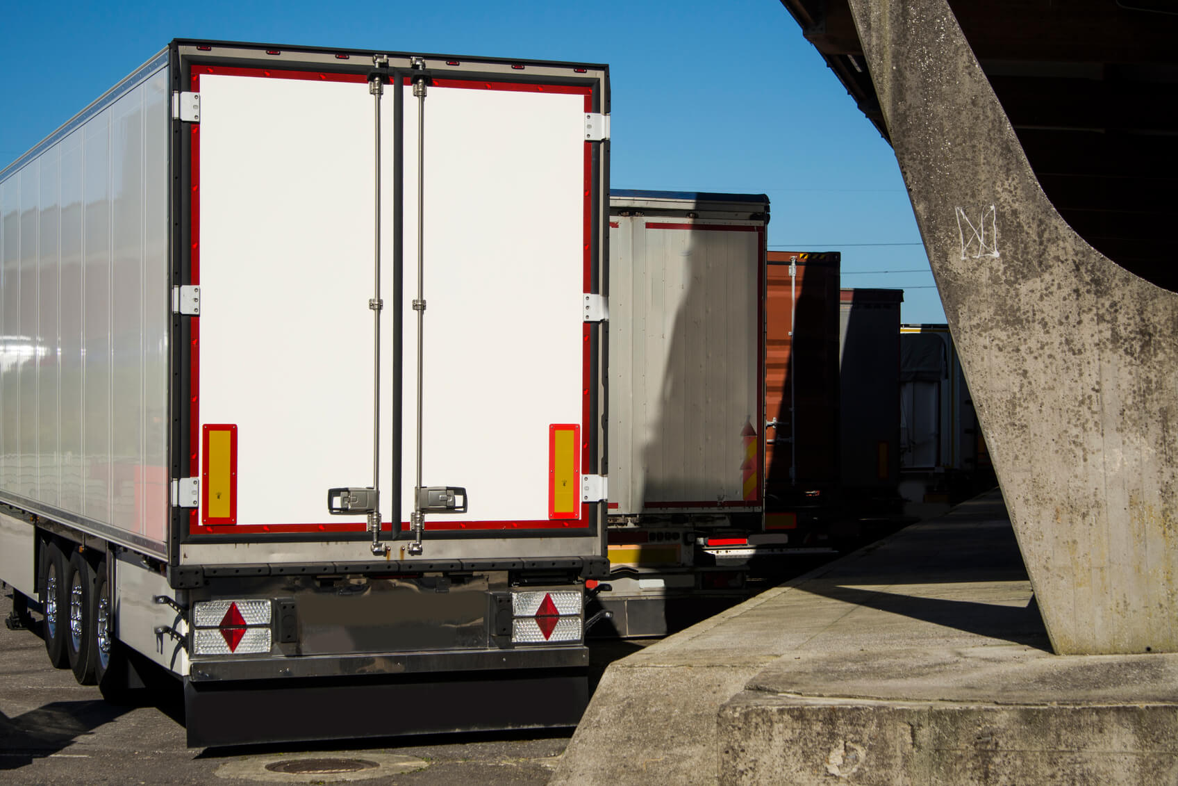 collection of parked heavy good vehicles shot from behind