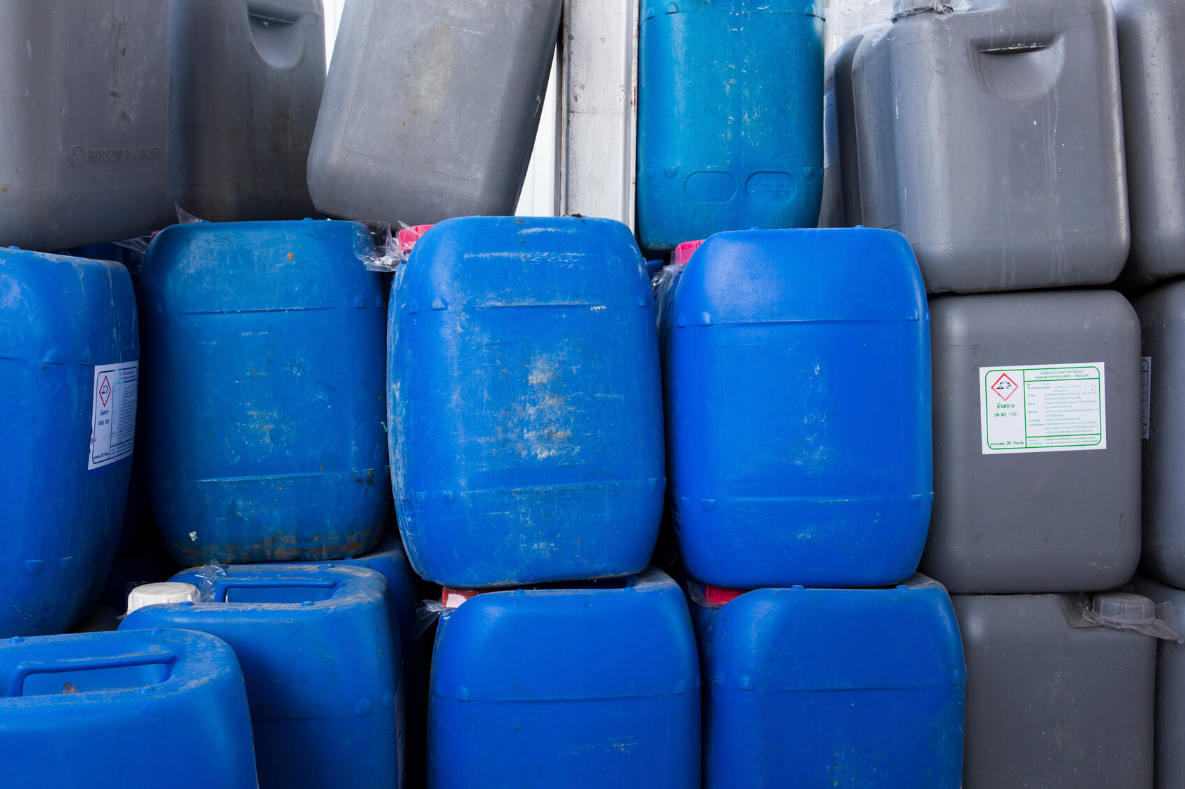 stack of plastic industrial liquid containers
