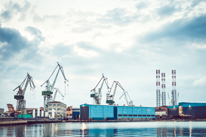 daylight photo of waterside shipping yard