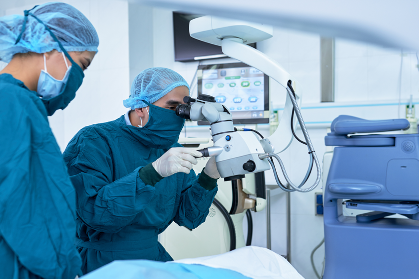 male and female in scrubs using medical technology