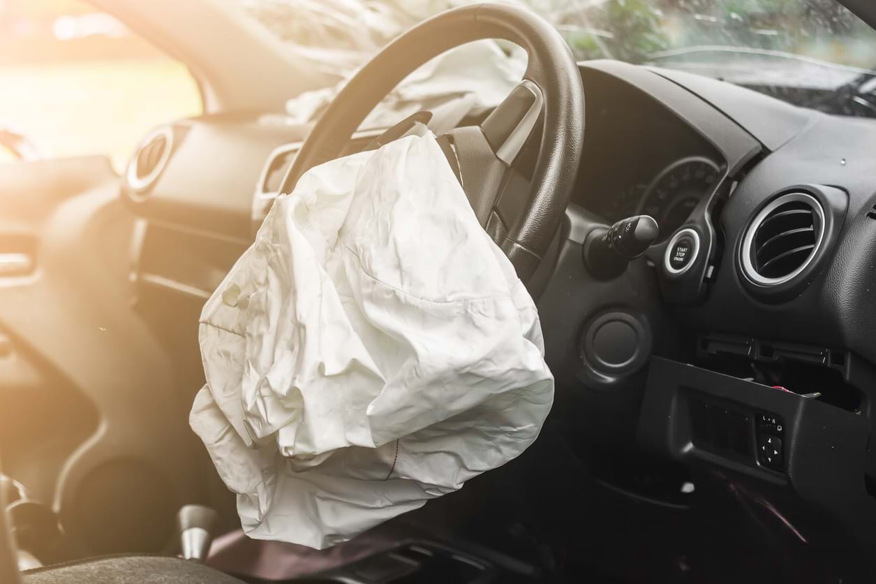 An airbag inflated from the steering wheel of a car which has been in an accident