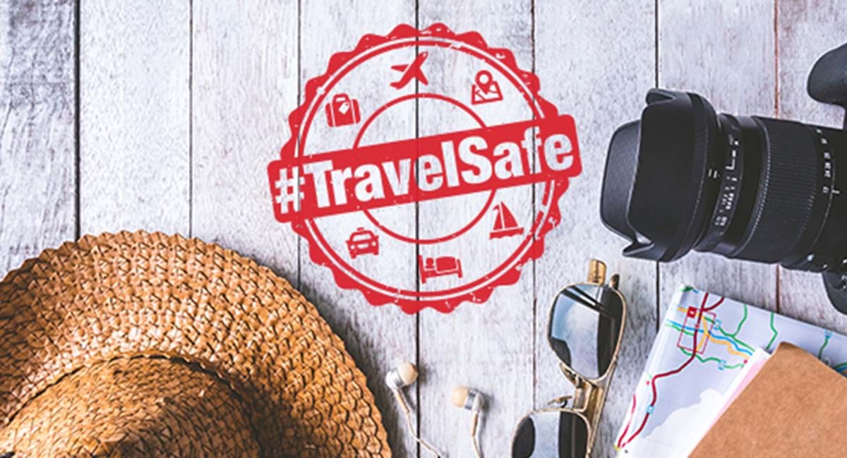 Sun hat, map, camera, sunglasses for a road trip