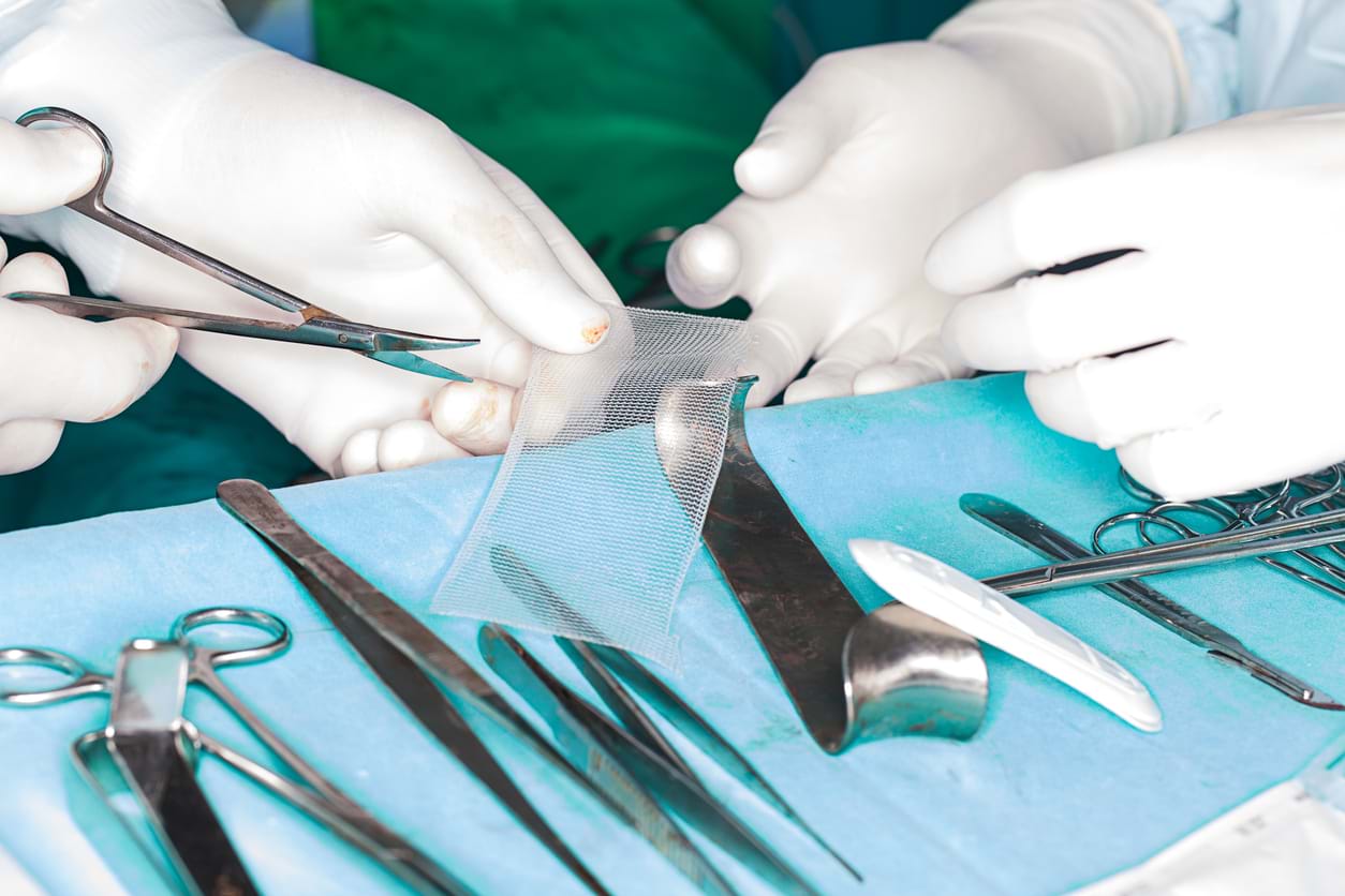 Surgeons handling medical equipment
