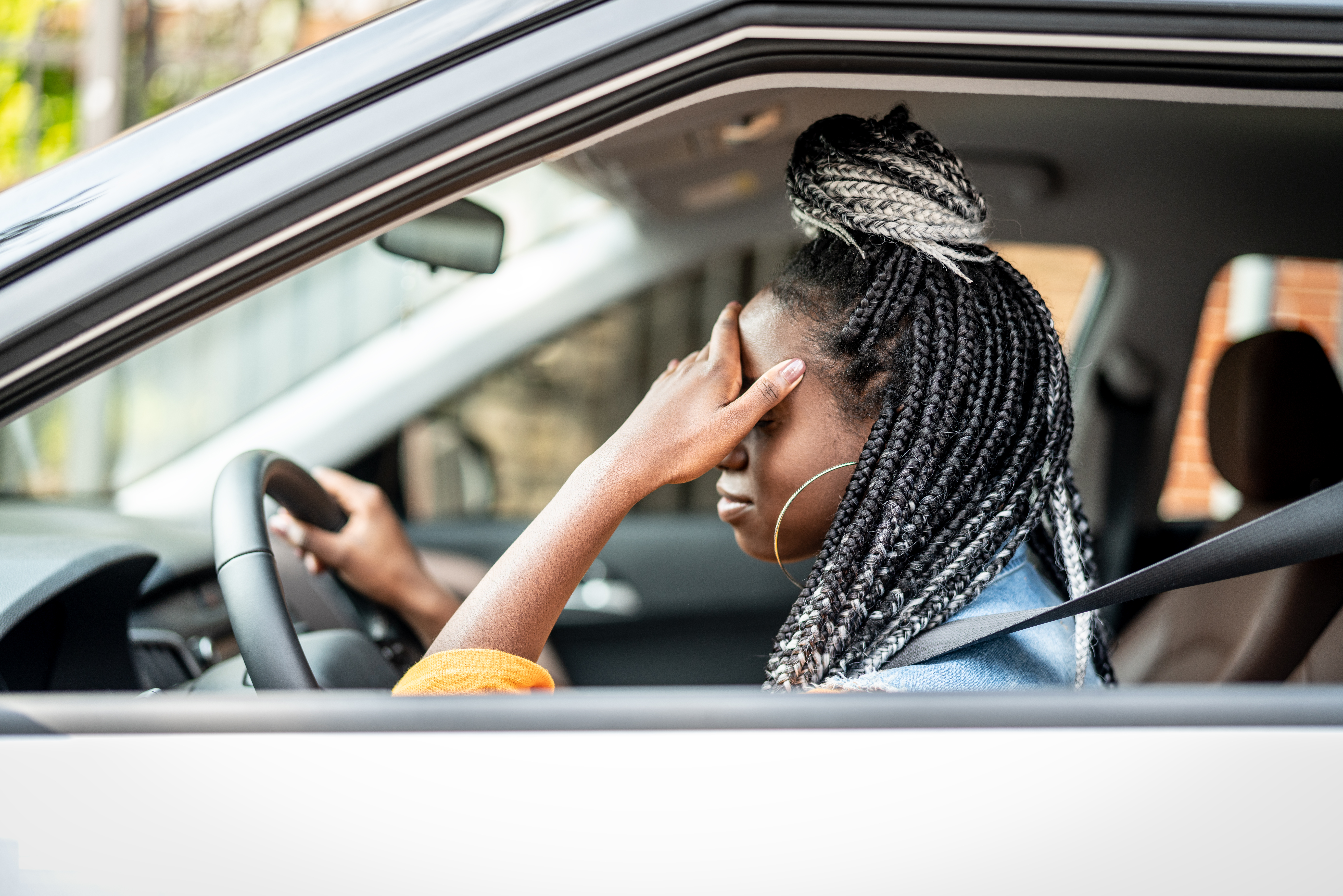 Woman with head in her hands following accident