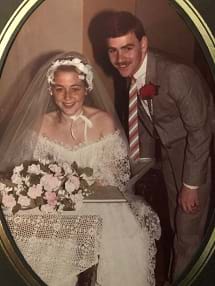 A sepia photo of a couple happy on their wedding day