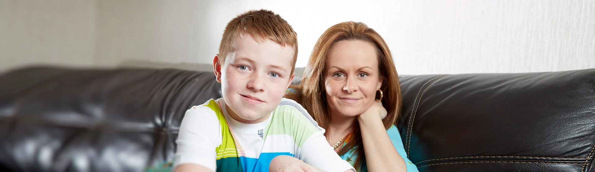 A photo of Adam, our child accident claim client, and his mum at their home