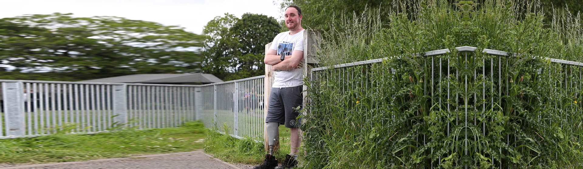 Our amputation claims client, Ben, stood in a local park. 
