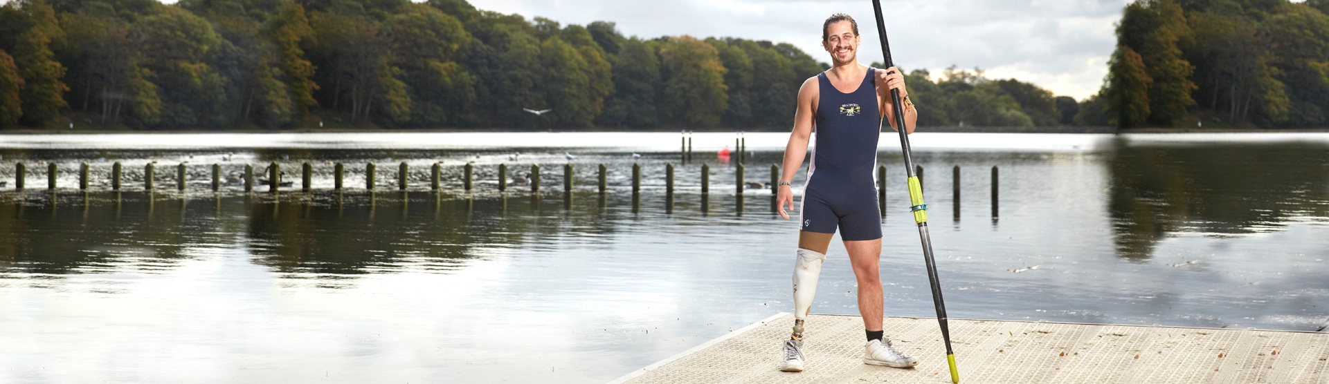 Matthew, our Cauda Equina client, standing on a dock. 