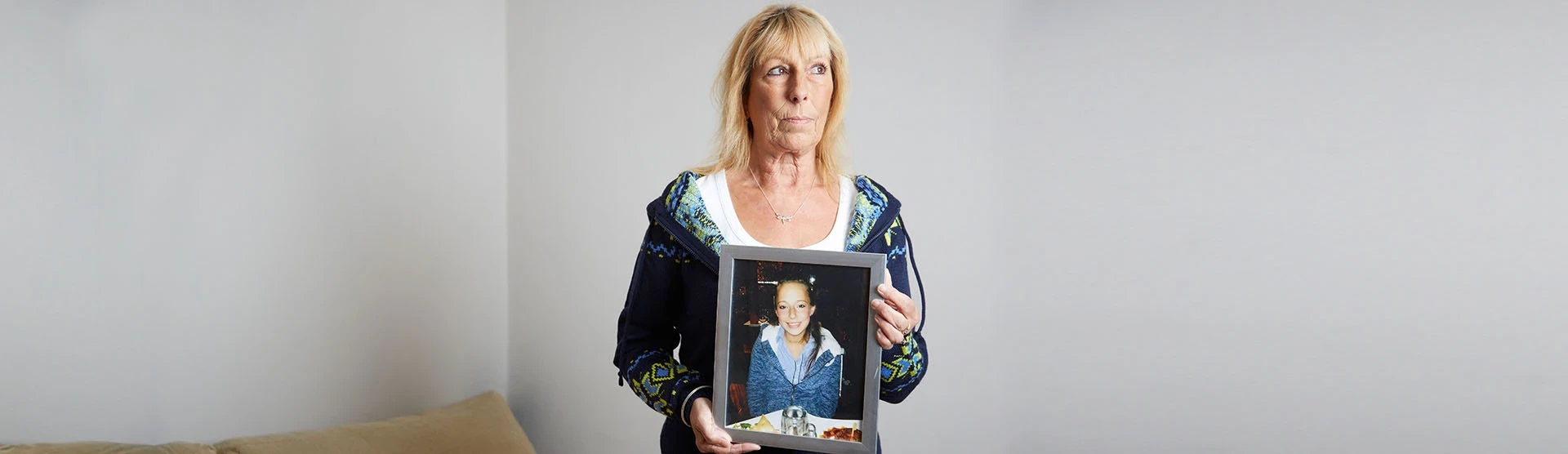 Our medical negligence and misdiagnosis client, Ruth, holding a photo of her daughter.