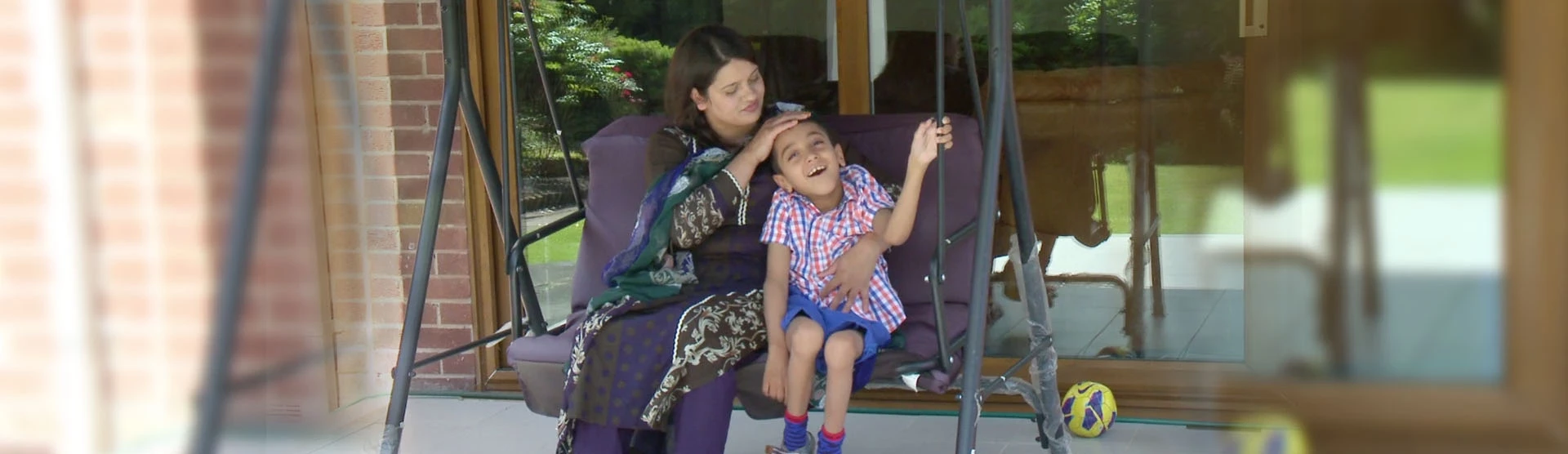 Bilaal, our birth injury client, sat with his mother.