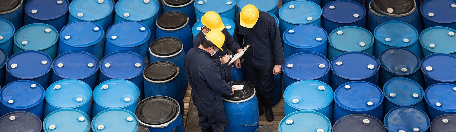 Three workers in an industrial setting, representing our industrial skin disease clients. 