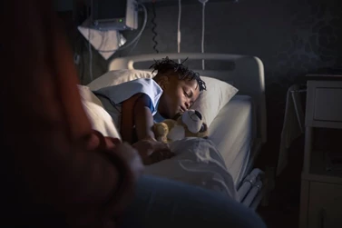 a photo of a child in a hospital bed