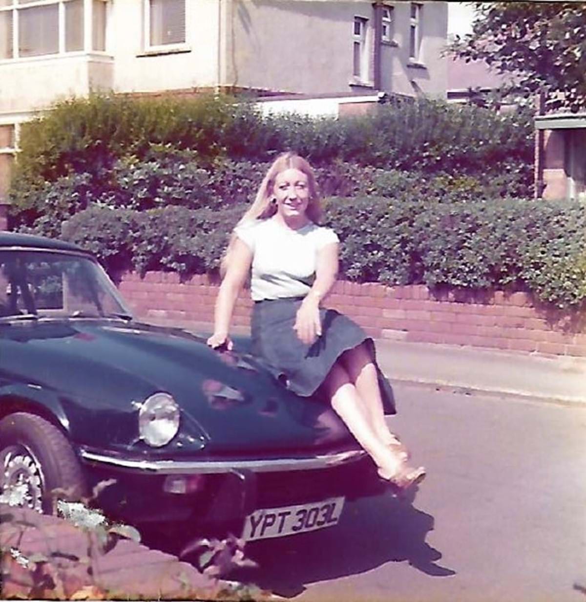 Elizabeth Jackson sitting on a car