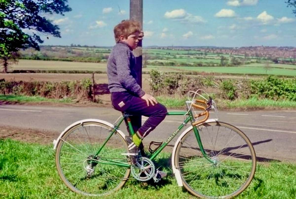 A young boy sat on a bike