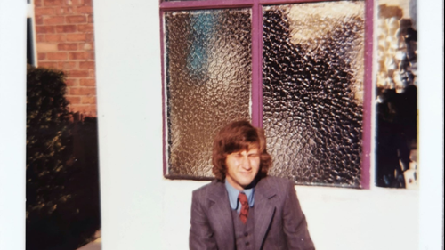 Mr Oldfield sat by a window